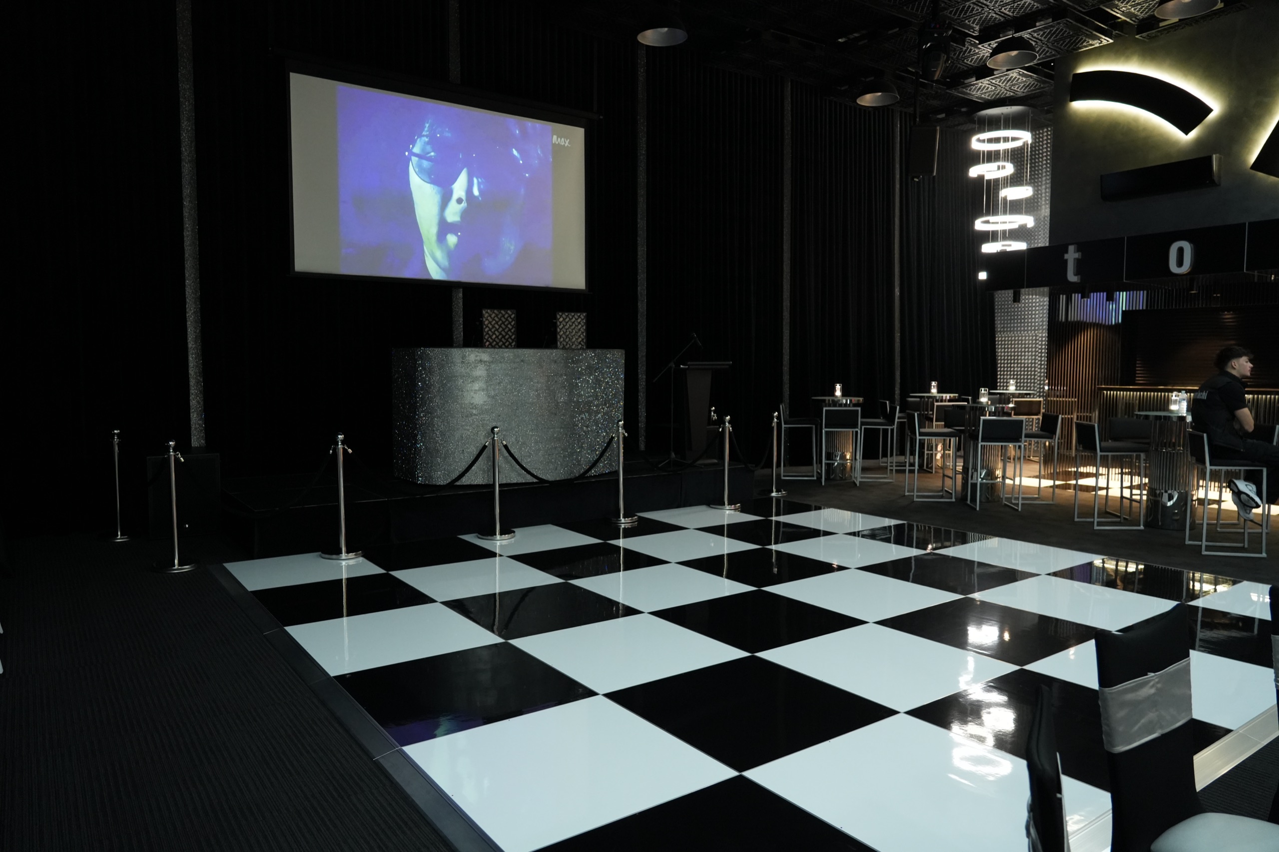 Tomiachi’s projection screen, DJ booth and chequered presentation floor