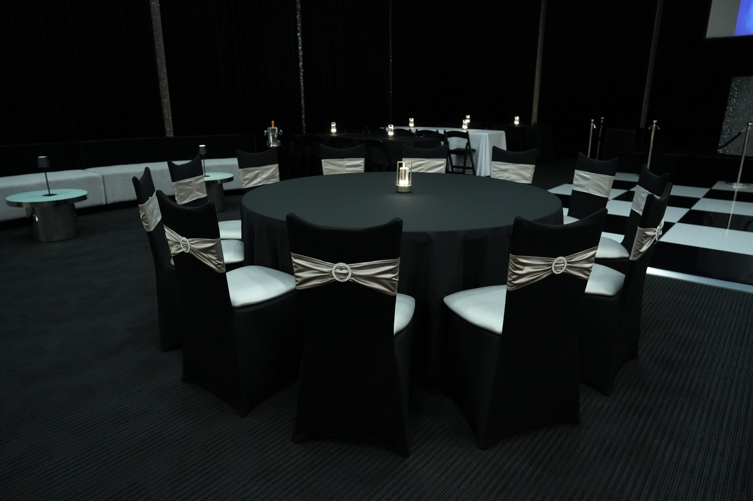 Tomiachi room arranged with dining tables beside the chequered dance floor